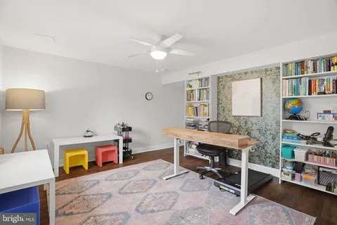 a room with furniture a bookshelf and a window