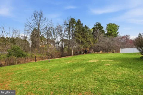a view of a field with trees in the background