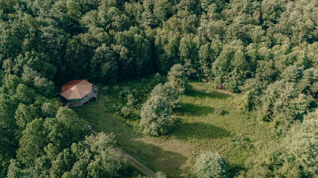 an aerial view of a house with a yard