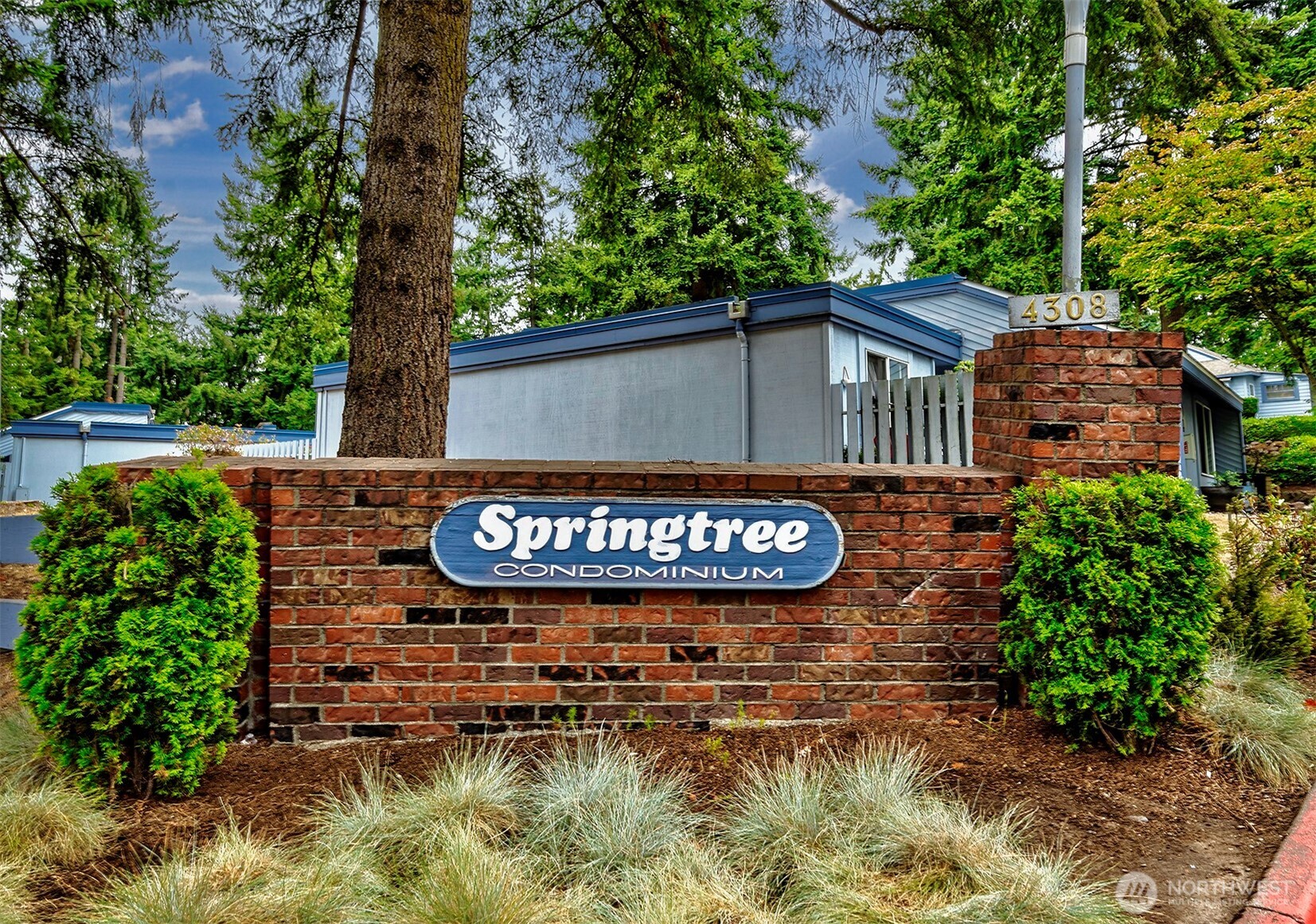 4308 Northeast Sunset Boulevard, Unit P1 Renton, WA 98059 - Photo 20 of 20 a sign that is sitting on a brick wall