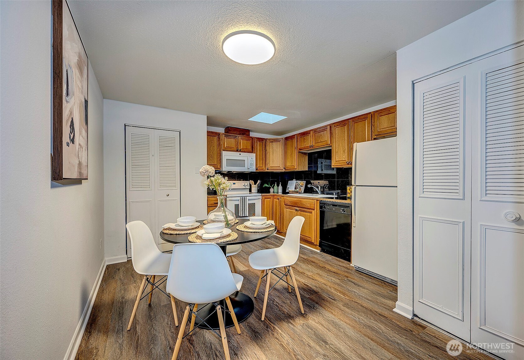4308 Northeast Sunset Boulevard, Unit P1 Renton, WA 98059 - Photo 4 of 20 a view of a dining room with furniture and wooden floor