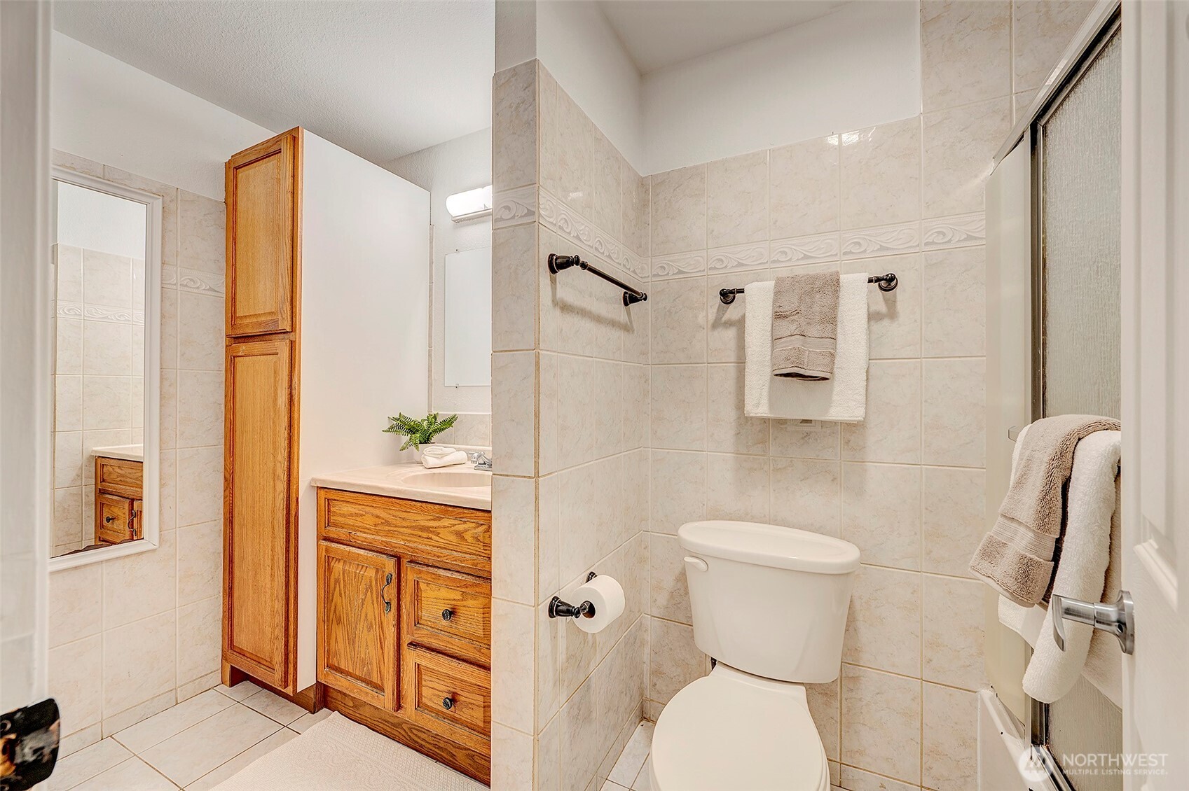 4308 Northeast Sunset Boulevard, Unit P1 Renton, WA 98059 - Photo 9 of 20 a bathroom with a toilet sink and mirror