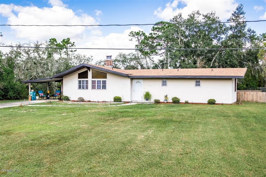 4004 Golfview Road Sebring, FL 33875 - Photo 1 of 1 a view of a backyard with plants and large trees