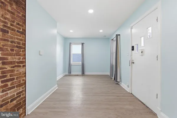 a view of a hallway with wooden floor