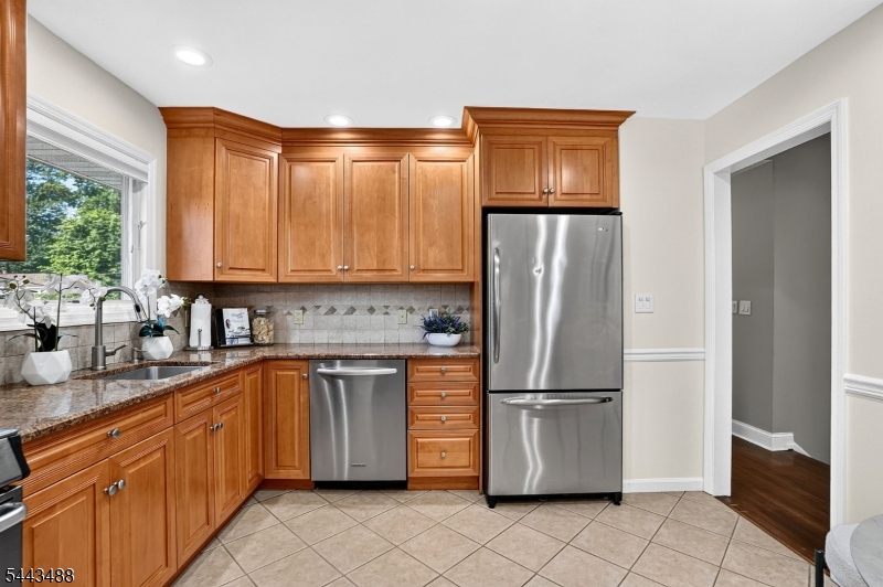 151 East Prospect Street Clark, NJ 07066 - Photo 10 of 31 a kitchen with stainless steel appliances granite countertop a refrigerator a stove a sink and a microwave