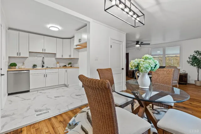 a view of a dining room with furniture and a kitchen