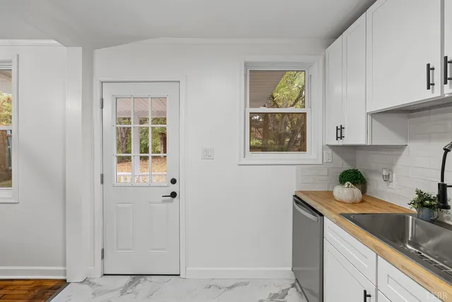 a kitchen with sink cabinets and window