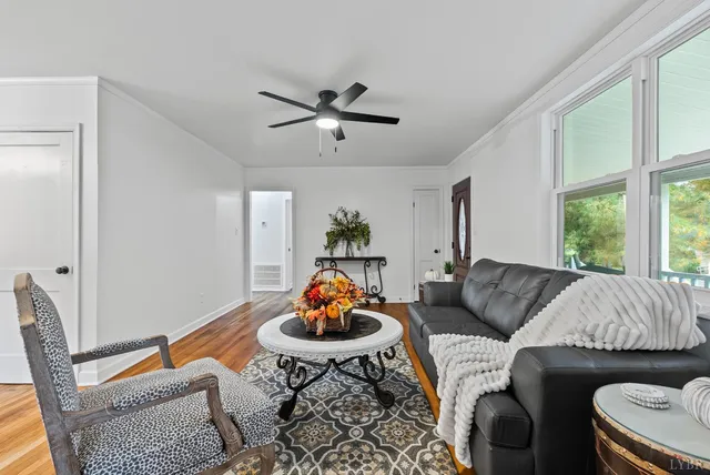 a living room with furniture kitchen and a window