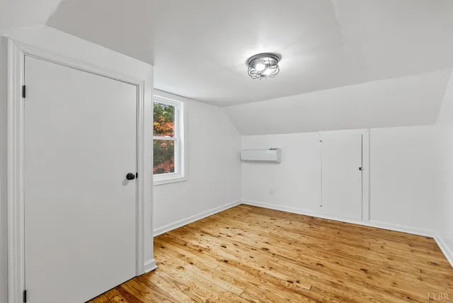 a view of a room with wooden floor and closet