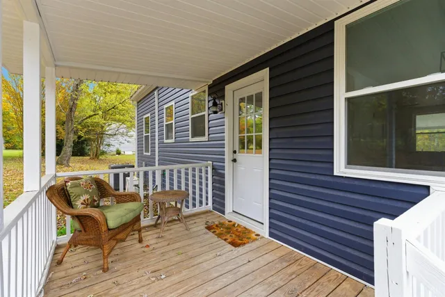 a balcony with wooden floor and furniture