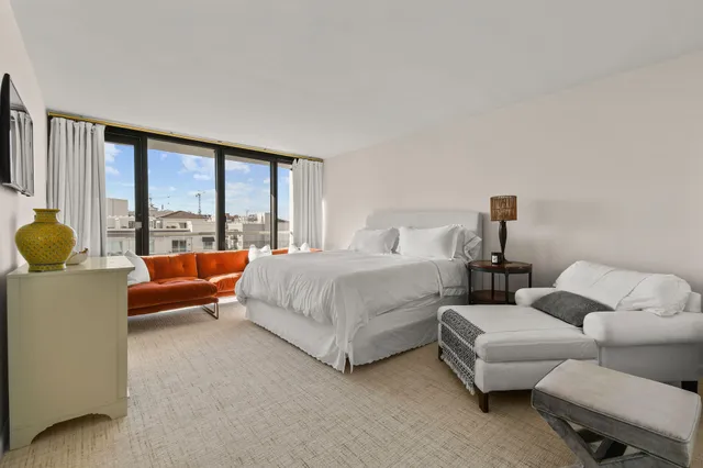 a white bath tub sitting in a bathroom next to a window