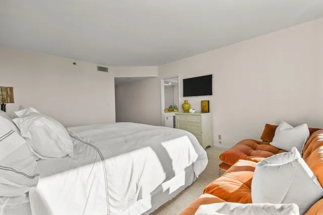 a spacious bathroom with a tub sink and mirror