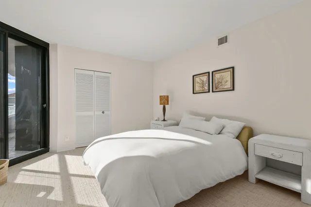 a room with furniture and potted plants