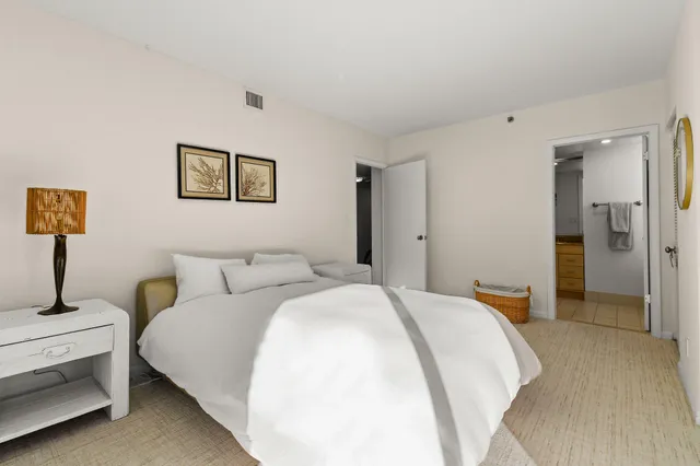 a dining room with furniture and a potted plant