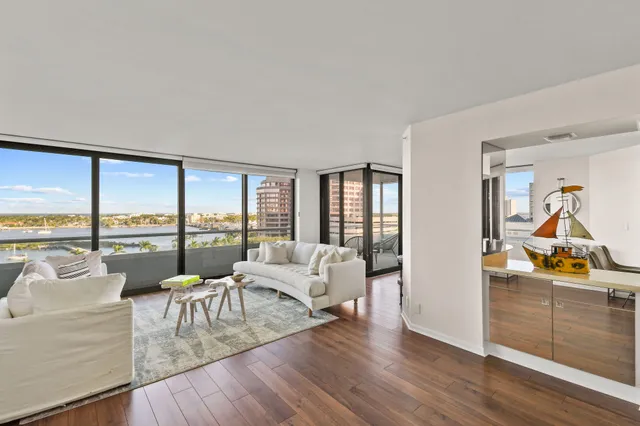a living room with furniture and a large window with outer view