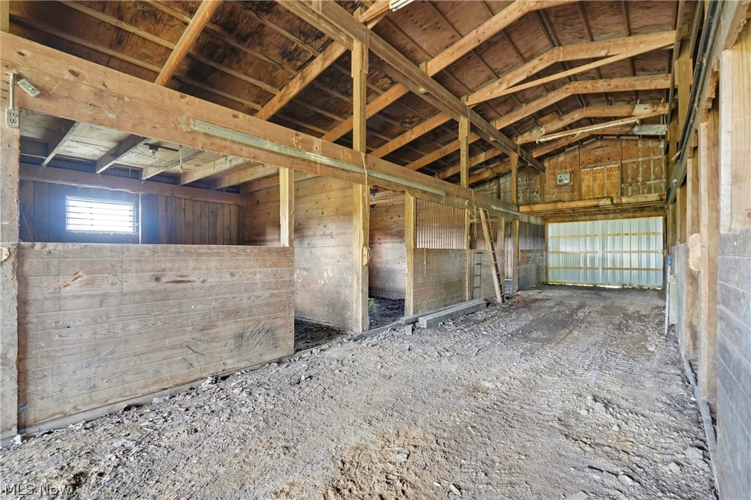 82 State Route Newton Falls, OH 44444 - Photo 11 of 30 Open barn interior featuring wood beam construction and multiple stalls