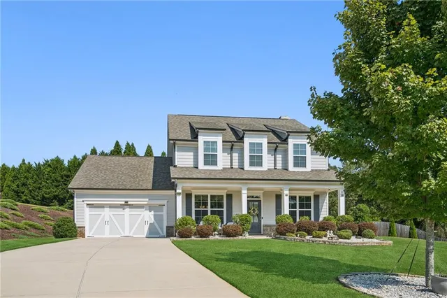 a front view of house with yard and green space