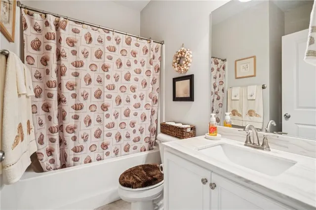 a bathroom with a sink toilet and a mirror