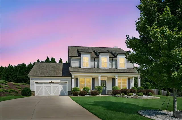 a front view of a house with a yard