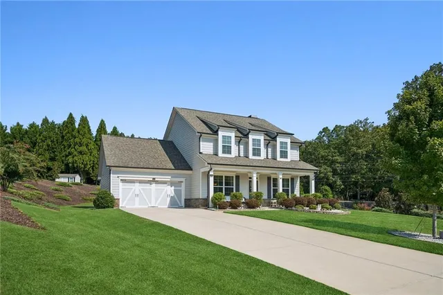 a front view of a house with a garden