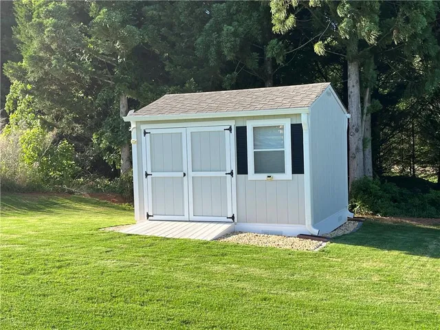 a view of a backyard with large trees