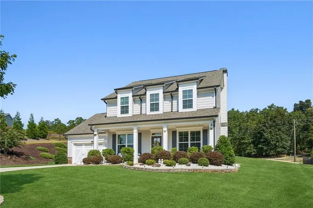 a front view of a house with a yard