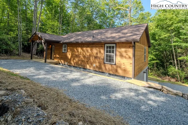a view of a wooden house with a outdoor space