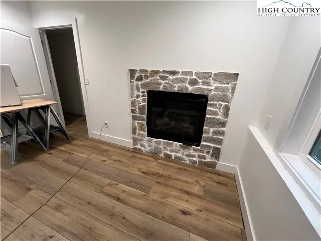 a view of living room with furniture and a fireplace