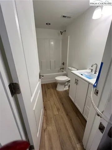 a bathroom with a sink a toilet a toilet and a window