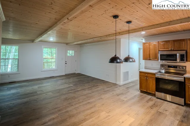 a view of a kitchen with a sink and a stove top oven