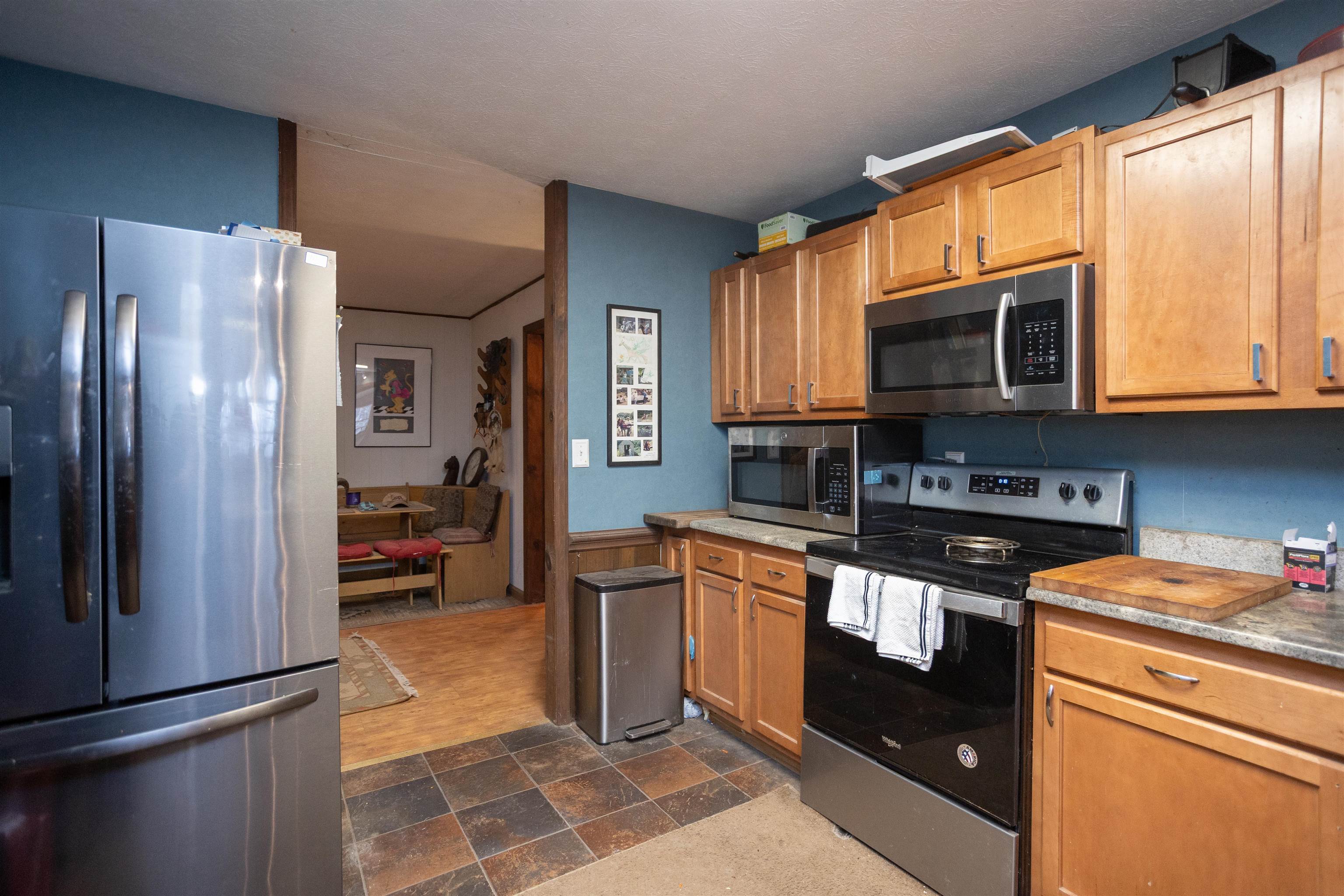 12619 Cardinal Forest Drive Fulks Run, VA 22830 - Photo 9 of 23 a kitchen with stainless steel appliances granite countertop a refrigerator a stove a sink and a microwave