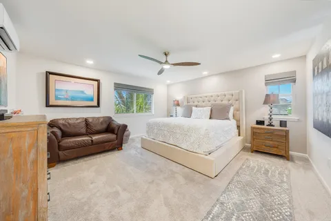 a bedroom with a large bed couch and a window