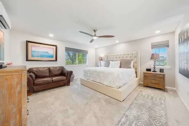 a bedroom with a large bed couch and a window