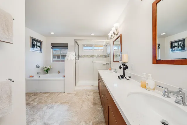 a bathroom with a tub sink and mirror