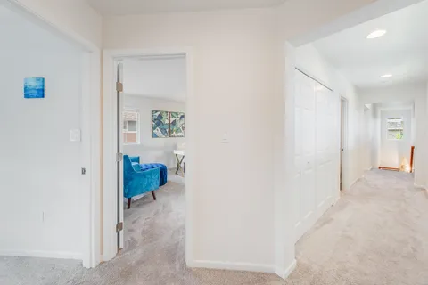 a living room with furniture and a painting