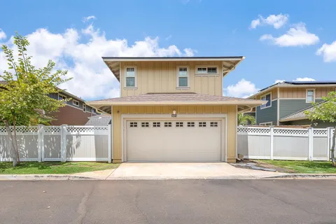 a view of a house with a yard and wooden fence