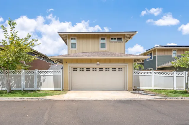 a view of a house with a yard and wooden fence
