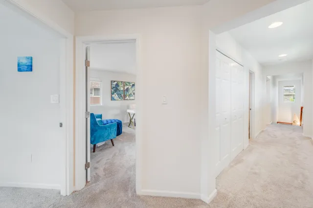 a living room with furniture and a painting