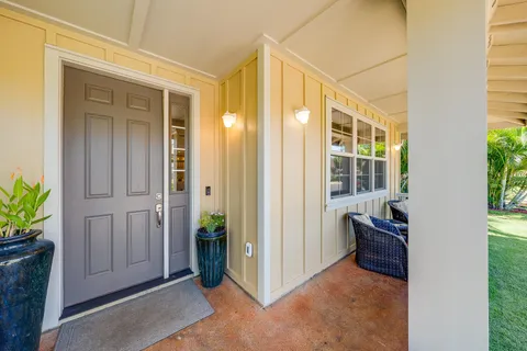 a view of front door and small yard