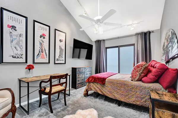 a bedroom with a bed and a chandelier