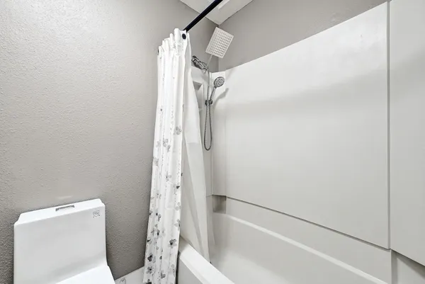 a bathroom with a shower and a toilet