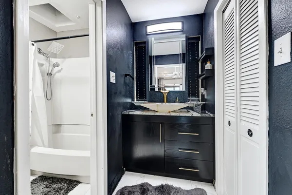 a bathroom with a sink and a mirror