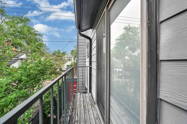 a view of a balcony with wooden floor and stairs