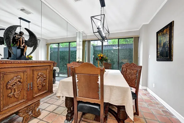 a dining room with furniture and window