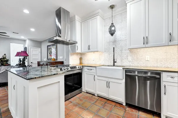 a kitchen with a sink stove and cabinets