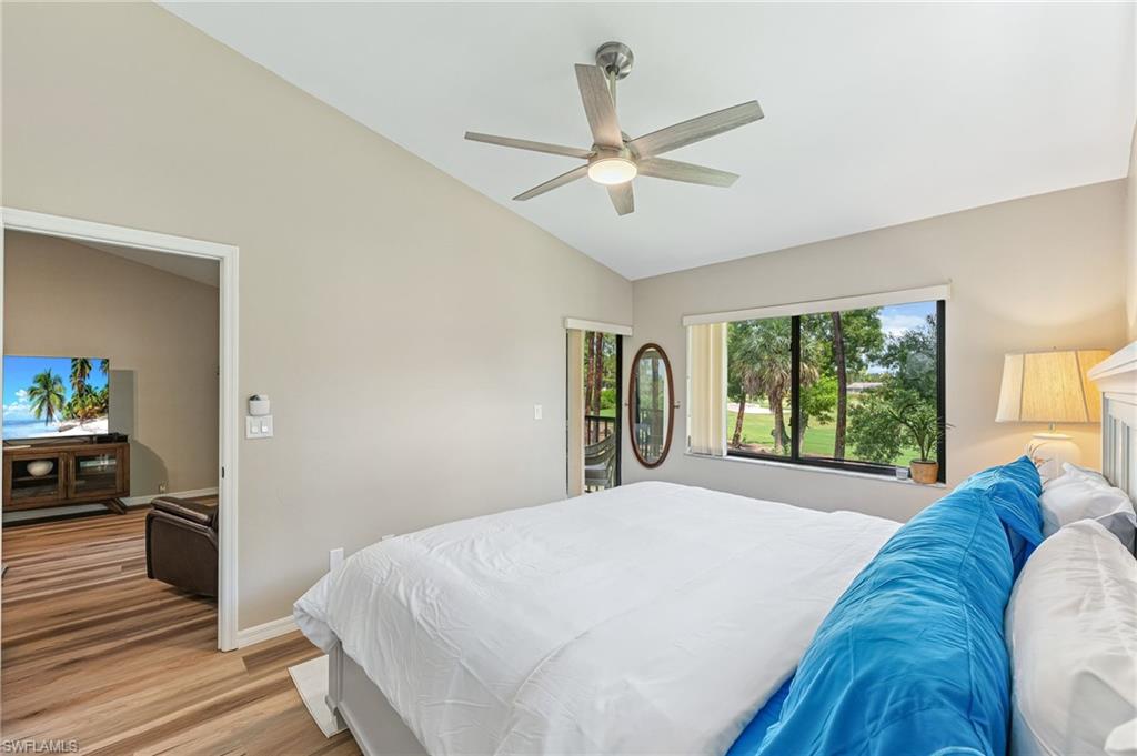 5857 Rattlesnake Hammock Road, Unit 208 Naples, FL 34113 - Photo 14 of 24 a bed sitting in a bedroom next to a window