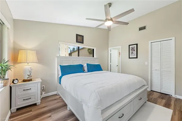 a bedroom with a large bed and a window