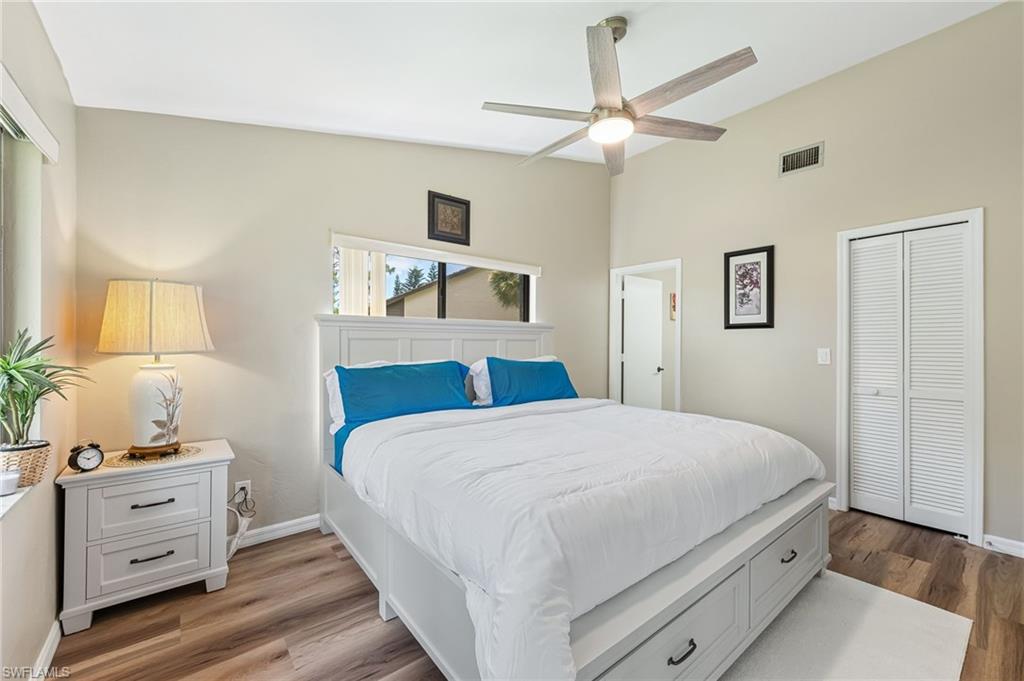 5857 Rattlesnake Hammock Road, Unit 208 Naples, FL 34113 - Photo 15 of 24 a bedroom with a large bed and a window