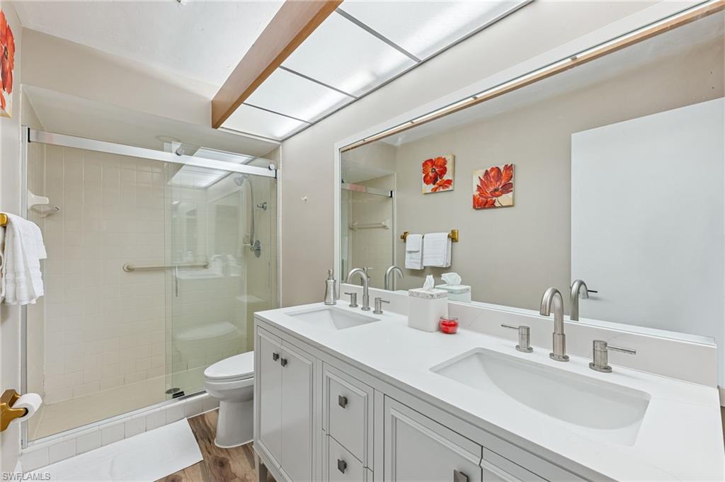 5857 Rattlesnake Hammock Road, Unit 208 Naples, FL 34113 - Photo 16 of 24 a bathroom with a sink a toilet and shower