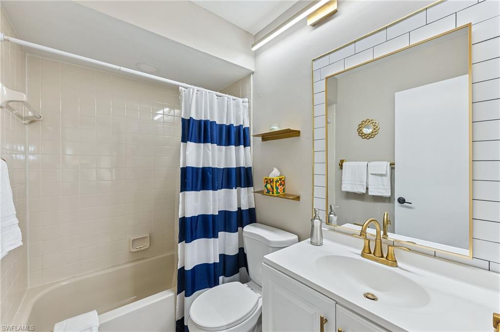 5857 Rattlesnake Hammock Road, Unit 208 Naples, FL 34113 - Photo 19 of 24 a bathroom with a sink a toilet and shower